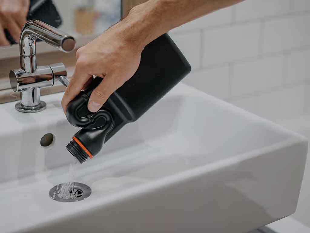 Someone using drain cleaner